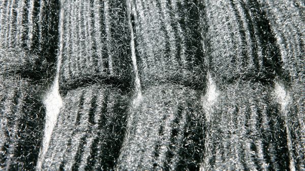 A bunch of steel wool arranged on a white background. 