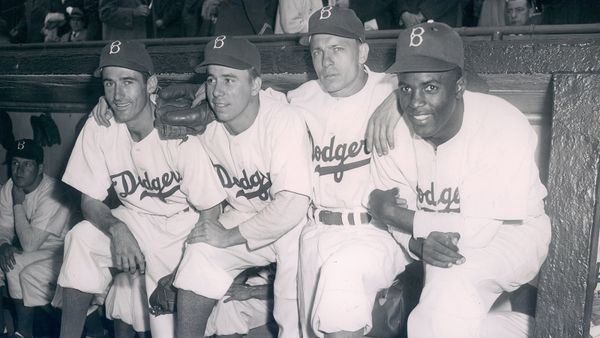 Men in black and white uniforms outdoors.