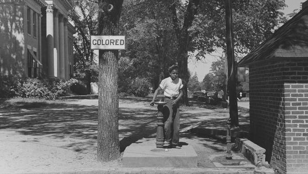 Two people outdoors, men and women, in black and white.