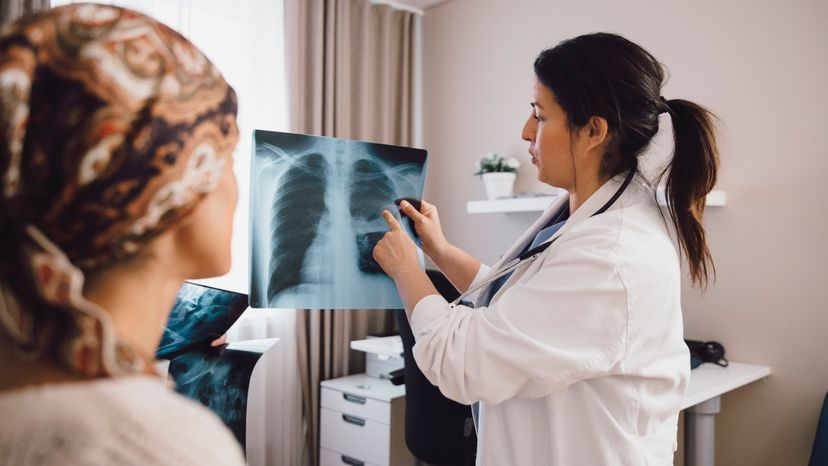 A doctor talking to a patient about their X-ray. 