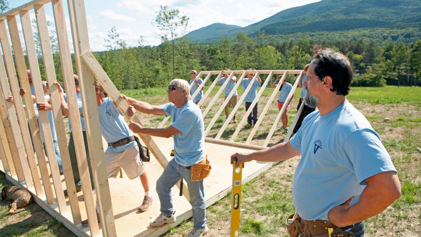 A group of men building a house. 