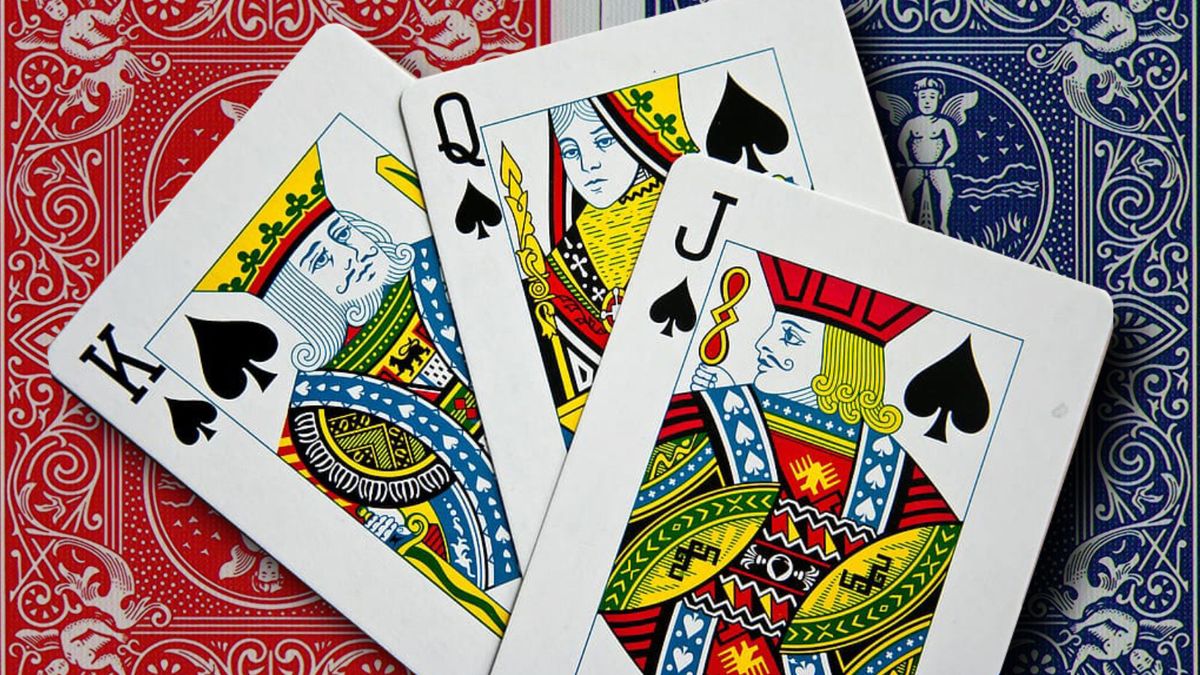 A set of three playing cards showing a Jack, Queen and King. All