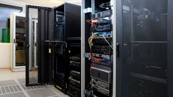 A large rack of computer equipment in a data center storage. 