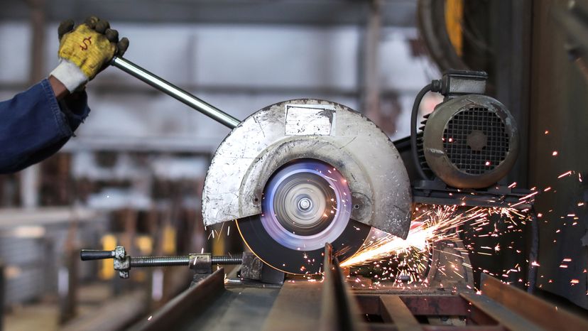 A circular saw being used in a scrap metal recycling facility. 