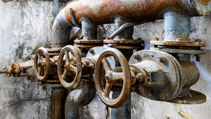 Old rusted pipe valves in an old building. 