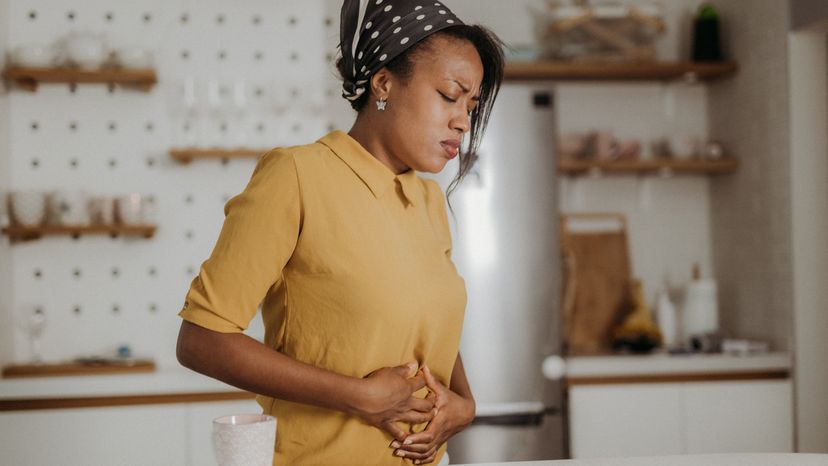 A woman suffering from stomach pain. 