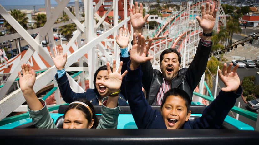 A group of young adults on a roller coaster ride. 