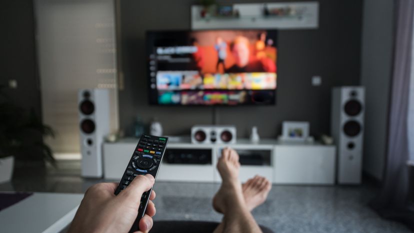 A woman browsing through television channels.