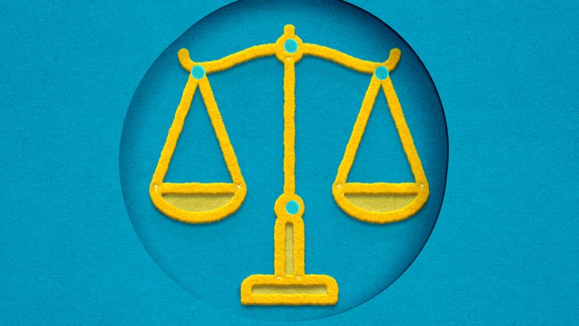 Scale of justice drawn in yellow against a blue background. 
