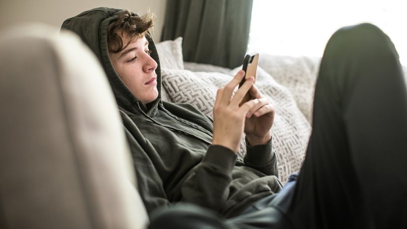 A teenage boy using his smartphone. 
