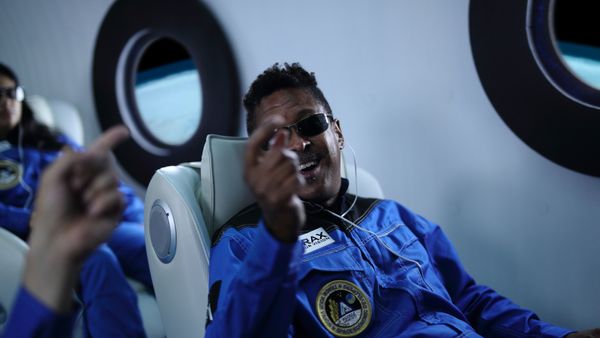 A commercial space traveler laughing with friends on a spaceship. 