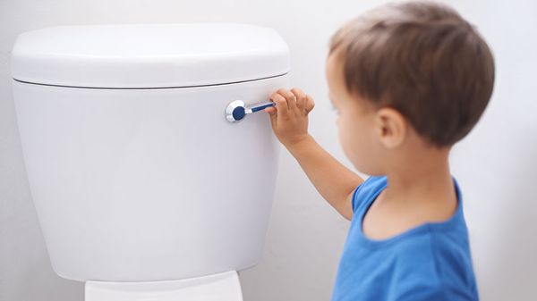 boy flushing toilet