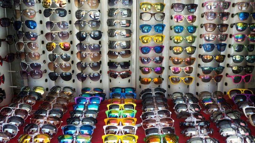 Different sunglasses displayed on a table. 