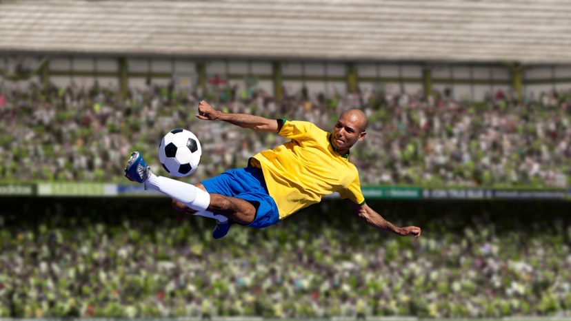 A football player kicks the ball.