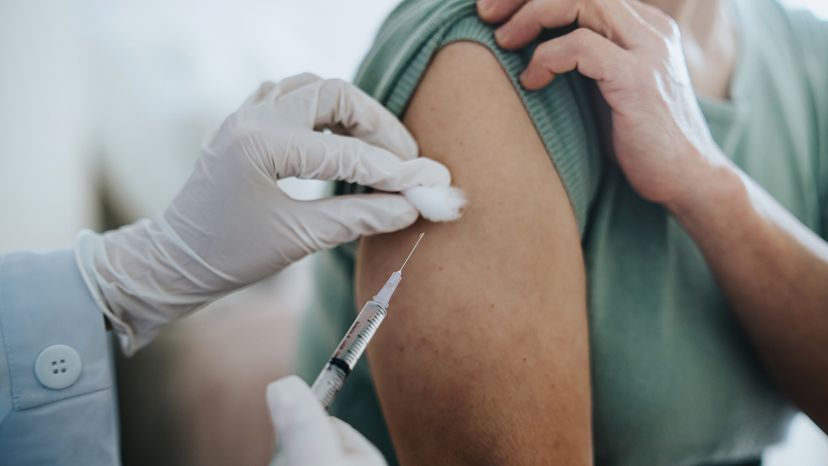 A close up of a woman getting vaccinated. 