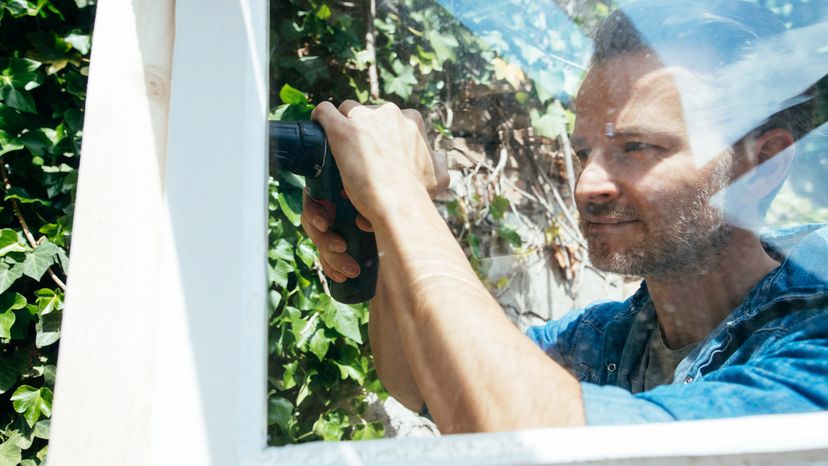 A man installing windows. 