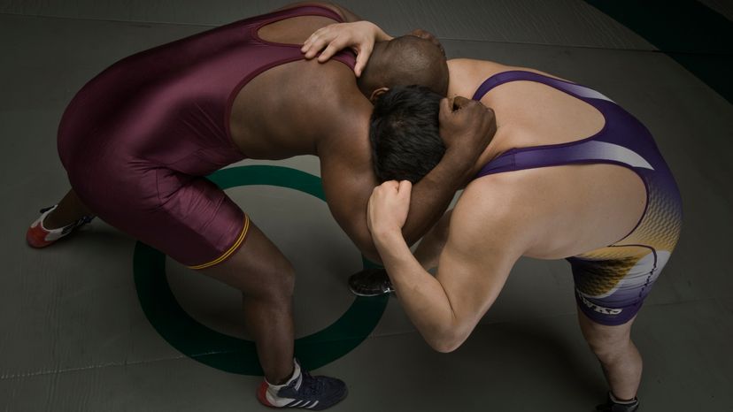 Two wrestlers wrestling.