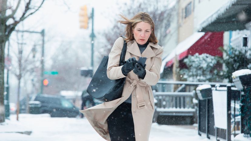 A woman walking on a windy winter day. 