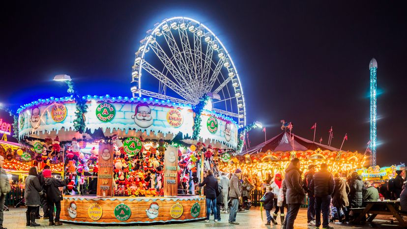 A view of an amusement park with the Ferris wheel in the background. 