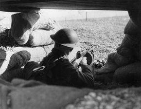 A soldier in a sandbagged trench circa 1940