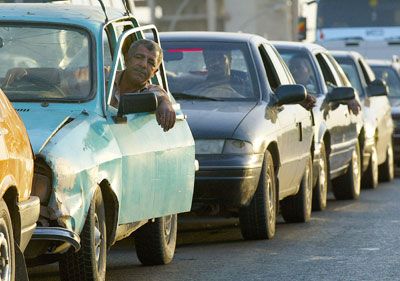 Men driving car outdoors as adults.