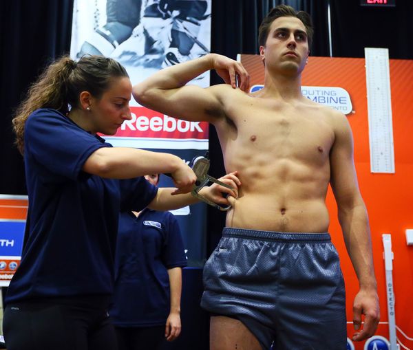 Hockey player Alex Tuch getting his body fat percentage measured