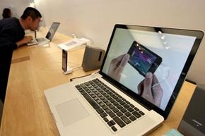 A customer looks at the new 17 inch MacBook Pro in an Apple store in 2009.