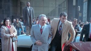 Businessman in suit outdoors near car.