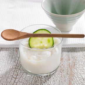 Bowl with curd and cucumber.