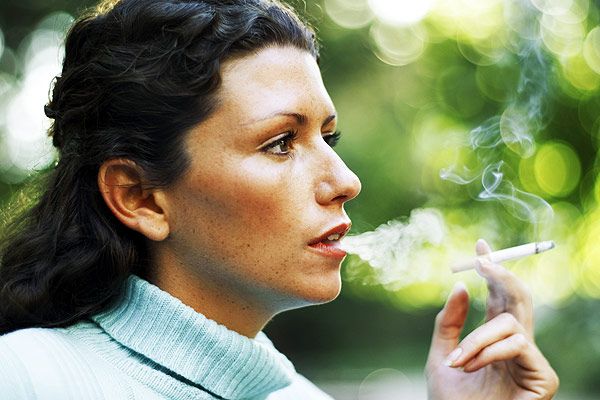 portrait of a young woman smoking a cigarette