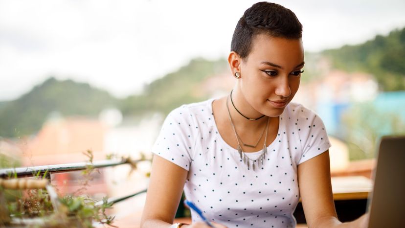 woman writing in café