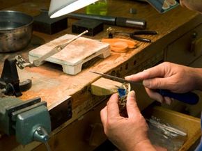 Craftsman working in front of workbench.