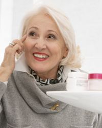 mature woman applying makeup