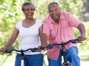 older couple smiling on bikes