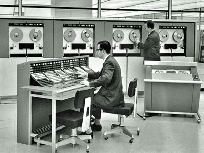 Two men operating a mainframe computer, circa 1960.