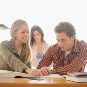 male and female student studying together