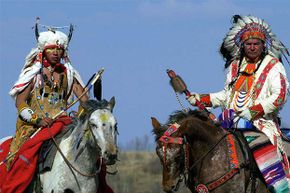 Canadian First Nation Cree Indians from Saskachewan are shown in traditional clothing.