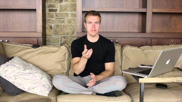 Men sitting alone on a sofa indoors.