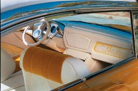The interior of the Marquis is done in gold and whitefabric and features a full-length center console.