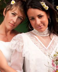 two women in wedding gowns