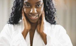 black woman touching face