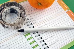 food journal, fruit and measuring tape