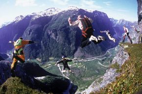 People base jumping off cliff. See skydiving pictures.