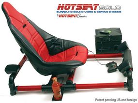 The HotSeat Solo is mounted on a steel chassis, with speakers mounted on the frame behind the chair and in front of the user's feet.