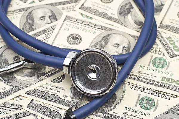 Stethoscope on a pile of money
