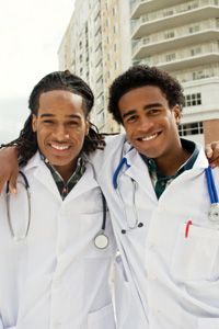 Why are these two students smiling? They were among the select few to be chosen for admission to medical school.