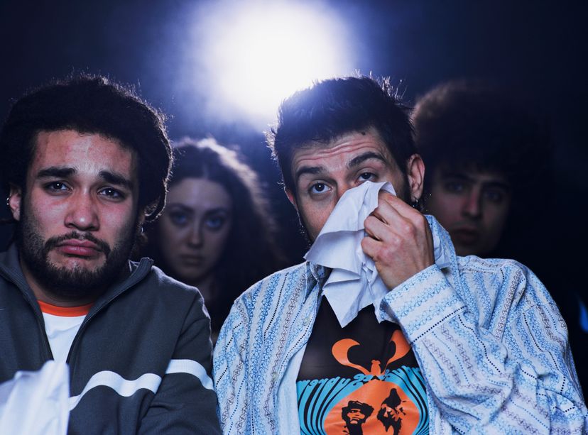 Men crying while watching movie