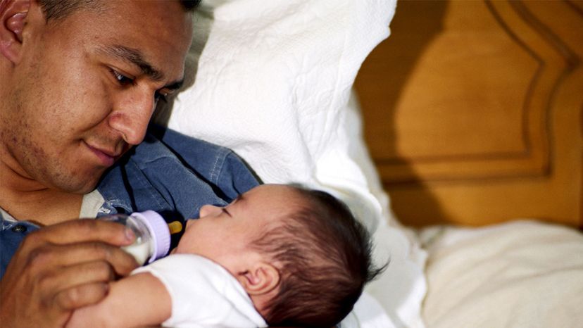 dad bottle feeding baby