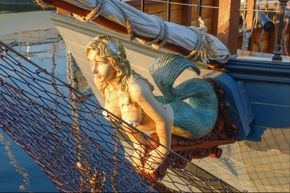 A mermaid figurehead adorns a ship.