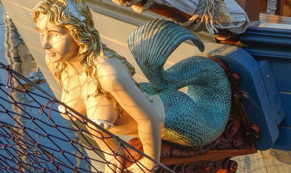A mermaid figurehead adorns a ship.